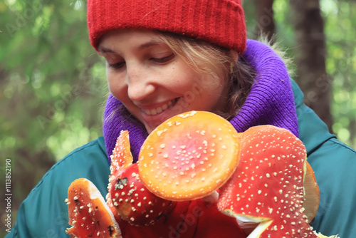 person fly agaric, woman holding fly agaric, dangerous poisonous mushroom, eating herbal medicine photo