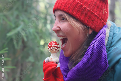 person fly agaric, woman holding fly agaric, dangerous poisonous mushroom, eating herbal medicine photo