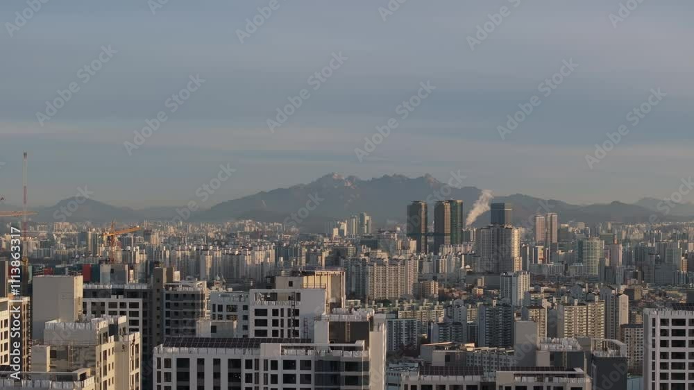 Aerial Morning View of Seoul Skyline with Bukhansan Mountain in the Background Aerial Morning View of Seoul Skyline with Bukhansan Mountain in the Background