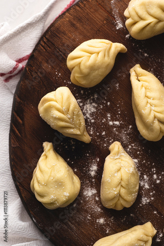 Culurgiones, typical ravioli of Sardinia. A first course of Sardinia: culurgiones or culugiornis, typical stuffed ravioli closed in an ear of wheat, best Sardinian culinary tradition, authentic taste  photo