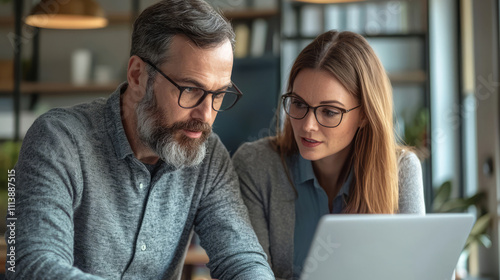 Male CEO discusses problem solving with female colleague in office