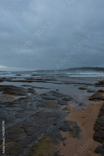 An overcast view of the rocky beach at Narrabeen, Sydney, Australia. photo