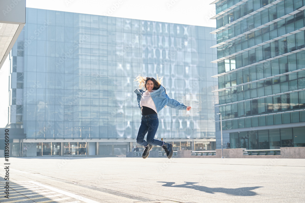 Young latin woman jumping in a cityscape expressing joy and freedom Young latin woman jumping in a cityscape expressing joy and freedom