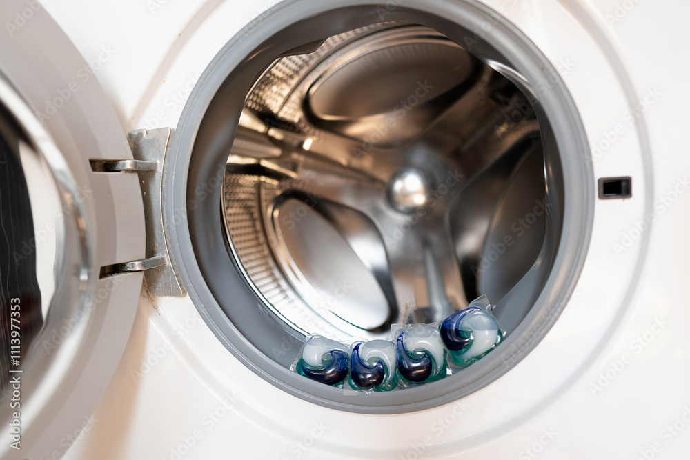 Laundry capsules placed in the washing machine drum, showcasing eco-friendly detergents that are safe for both health and the environment.