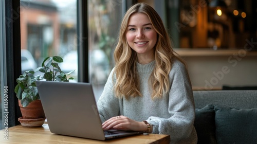 Free Download Young female adult working on laptop in cozy café setting. - GFXLoad