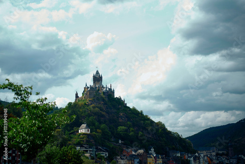 Majestic hilltop castle overlooking a 0uaint town under a cloudy sky, Moselle River, Germany photo