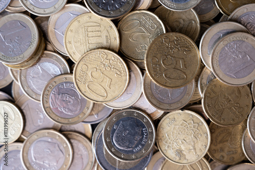 One and two-euro coins with a fifty-cent coin, European currency close-up photo