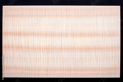 Close-up shot of exquisite figured maple wood veneer, showcasing its delicate, swirling grain pattern and soft, creamy color palette, ideal for design and craft backgrounds.