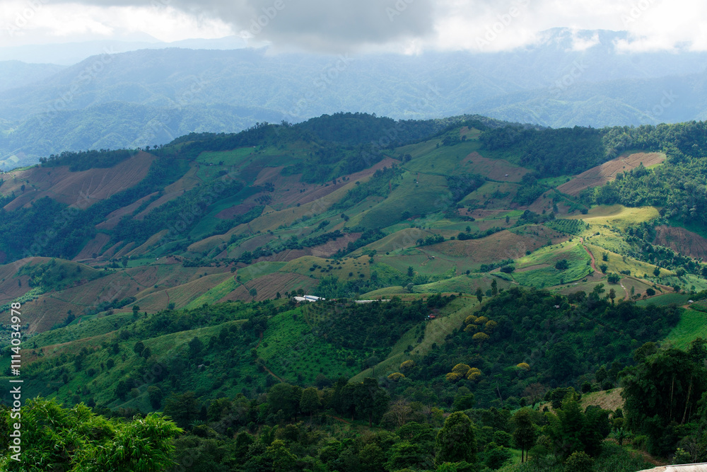 Lush Green Mountain Landscape with Rolling Hills and Cloudy Sky Lush Green Mountain Landscape with Rolling Hills and Cloudy Sky