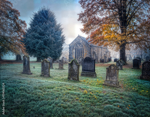 HIghly detailed old European style stone church in a beautiful graveyard in the fall photo