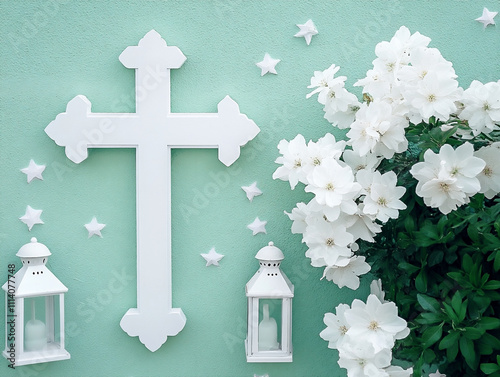 A white cross sits on a soft mint green wall