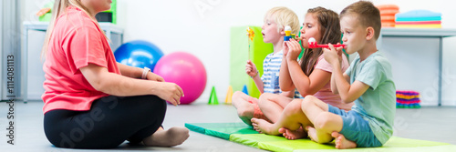 Group of young children making breathing exercises during physical therapy session. Kids in group physiotherapy.