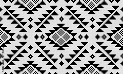 a fabric pattern composed of black geometric and white background designs.