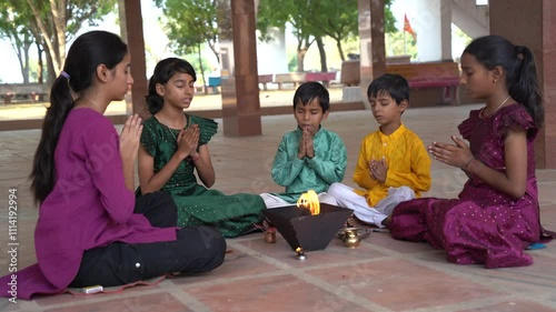 A Hindu family gathered around a sacred fire, performing a Yagya or havan