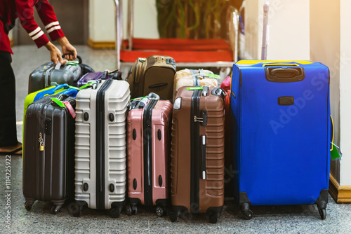 Many bag and luggage for loading into under vehicle or bus to prepare for trip in front of hotel. Several suitcases waiting for luggage pick-up bus to be taken. Selective focus. Trip or Tour concept.