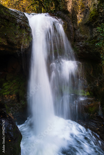 Waterfall at Moulin du Saut, an abandoned, 18th century, derelict mill in a forest on the Alzou river in the Lot region of France