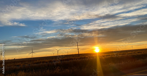 Beautiful and Dramatic Windmills during Sunset with saffron and blue sky with clouds