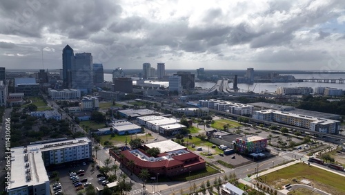Jacksonville, Florida city skyline beside St. Johns river downtown office buildings and streets working and living in coastal town in morning light as storm front passes over