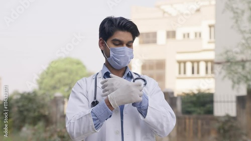 Indian Doctor Wearing Surgical Gloves photo