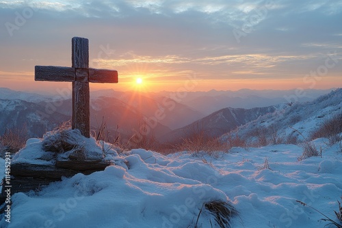 A wooden cross sits atop a snow-covered hillside, with a serene winter landscape in the background photo