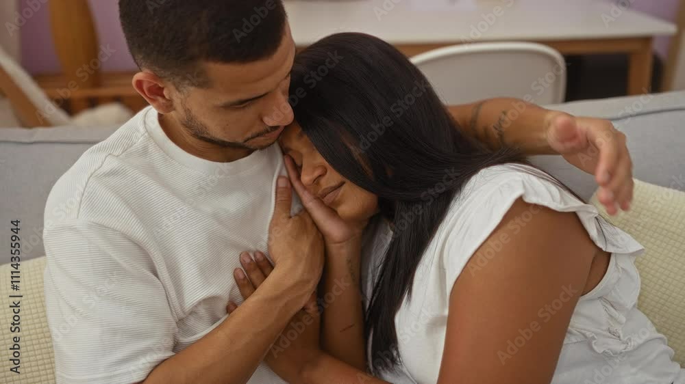 Couple embracing lovingly with man and woman sitting together in an indoor living room setting Couple embracing lovingly with man and woman sitting together in an indoor living room setting