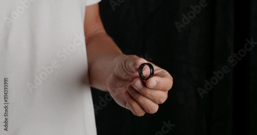Man Puts on a Smart Ring, Heart Rate, Blood Oxygen Tracker, Calorie Sleep Tracker. Close-up. 