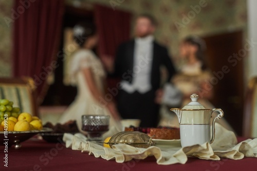 Fotografie Close up detail shot of ornately designed porcelain creamer and plate on red vel