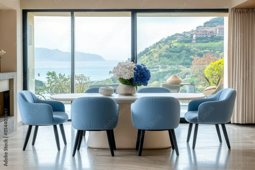 Obraz premium Blue dining table and chairs against panoramic windows with sea view in luxury villa