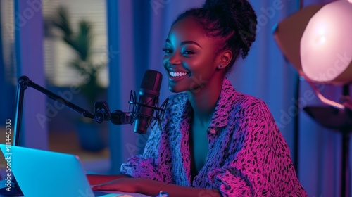 Smiling woman podcasting, using microphone and laptop in colorful room.
