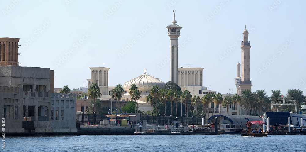 Obraz premium Beautiful view of historical and traditional buildings of Arab culture in Bur Dubai district from Dubai Abra while crossing in boat.