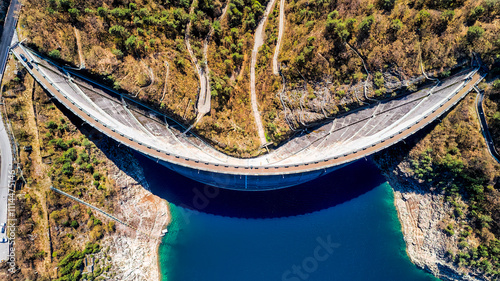 Aerial view, dam of Diga di Ponte Cola -Valvestino, Lake Valvestino, Italy. Beautiful lake between the mountains. Cumulus clouds, blue sky photo