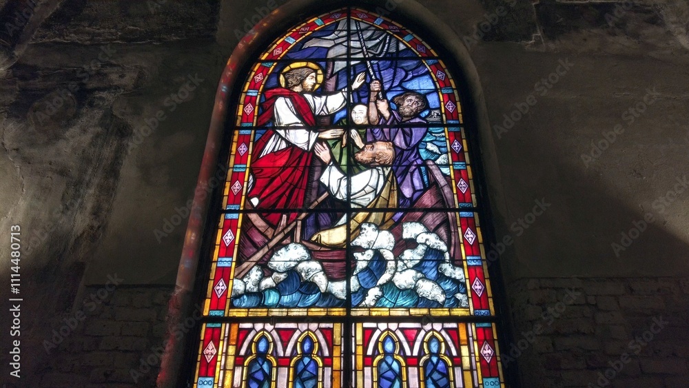 Europe, Italy , Milan 12,04,2024 stained glass window of a Christian church with colored glasses depicting scenes of the spirituality of the Catholic religion in San Cristoforo