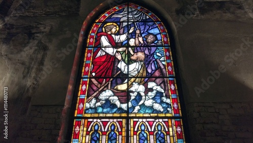 Obraz na płótnie Europe, Italy , Milan 12,04,2024 stained glass window of a Christian church with colored glasses depicting scenes of the spirituality of the Catholic religion in San Cristoforo w salonie