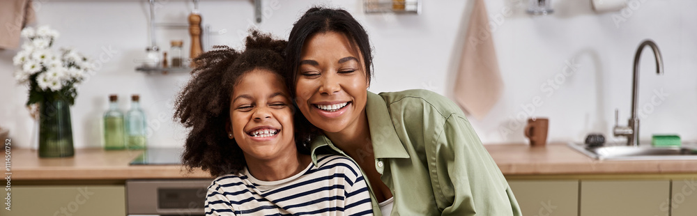 Laughter fills the air as a happy mother and her daughter enjoy quality time together. Laughter fills the air as a happy mother and her daughter enjoy quality time together.