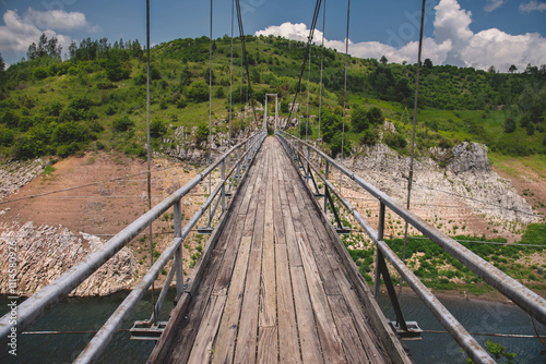 Obraz na płótnie Suspension Hanging Wooden Bridge across Uvac River w salonie