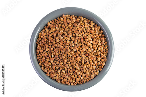 Raw buckwheat in ceramic bowl isolated on white background. Top view. Flat lay