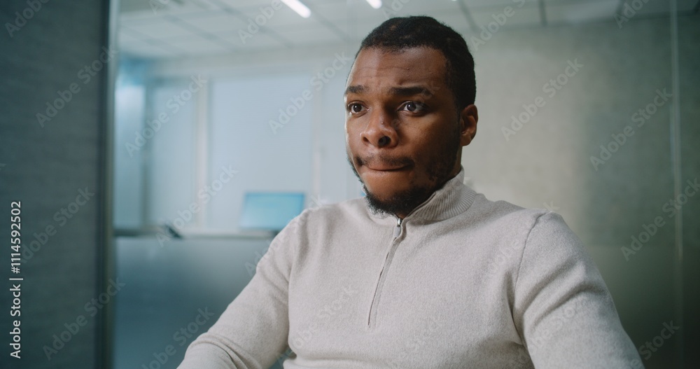 African American man works in advanced office: Successful marketing specialist or customer manager types on keyboard, chats with client or business partner about deal using PC. E-business. Rack Focus. African American man works in advanced office: Successful marketing specialist or customer manager types on keyboard, chats with client or business partner about deal using PC. E-business. Rack Focus.