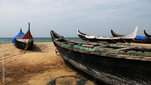 Fishing boats moored on the beach at Kovalam, Thiruvananthapuram, Kerala, India