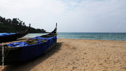 Fishing boats moored on the beach at Kovalam, Thiruvananthapuram, Kerala, India photo
