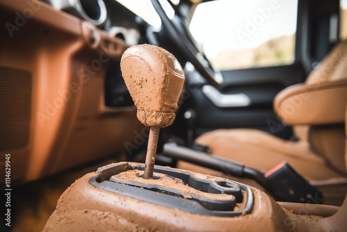 Close-up of a muddy gear shift in an off-road vehicle interior. photo