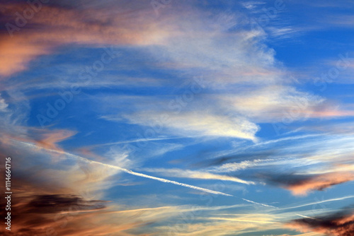 A beautiful blue sky with colorful clouds in late afternoon is seen here to be used as a background image or graphic element.