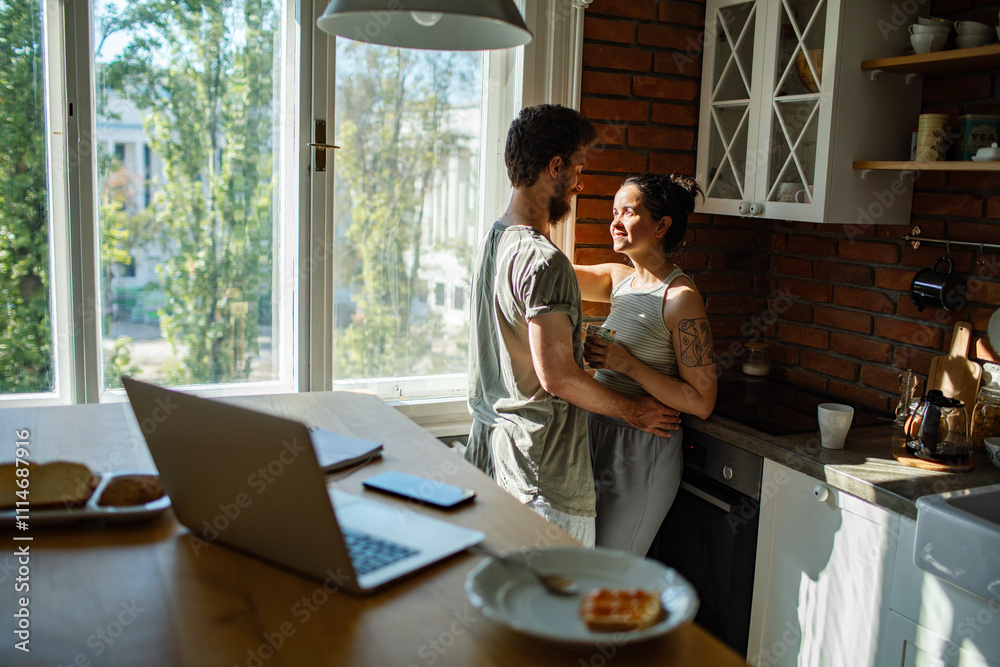 Young couple sharing a tender moment in the kitchen