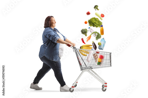 Overweight woman pushing a shopping cart with falling food products