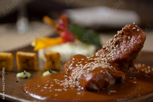 Mexican spicy sauce Adobo with pork chops and roasted sesame seeds, defocused close-up. photo