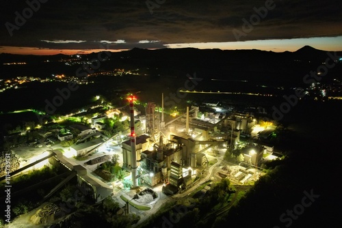 A dramatic aerial view of lime kilns illuminated at night, showcasing industrial heritage and the atmospheric beauty of this essential manufacturing site