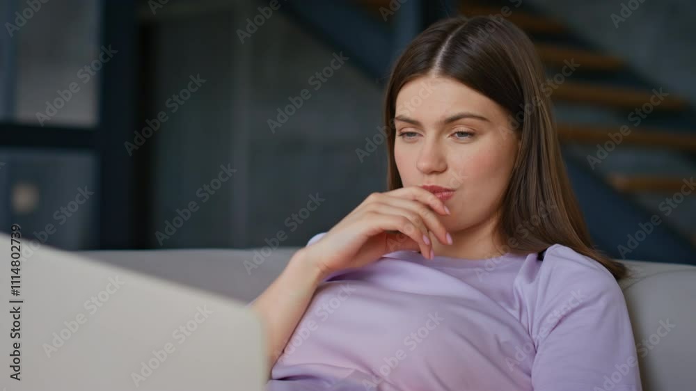 Thoughtful freelancer reading email using laptop at couch closeup. Woman online Thoughtful freelancer reading email using laptop at couch closeup. Woman online