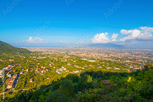 The photo of the Amalfi Coast from the land, with dramatic cliffs, colorful towns perched along the hills, and winding roads offering breathtaking views of lush Mediterranean landscapes