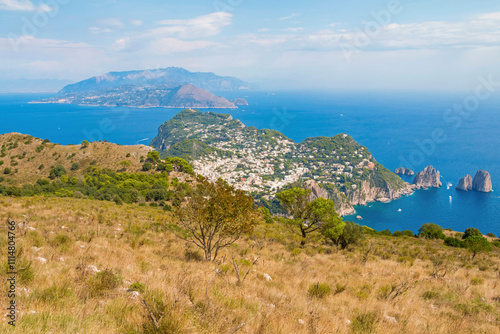 Obraz na płótnie view of Capri, including the Gardens of Augustus, with vibrant flowers, lush greenery, and panoramic vistas of the coastline and iconic Faraglioni rocks. w salonie