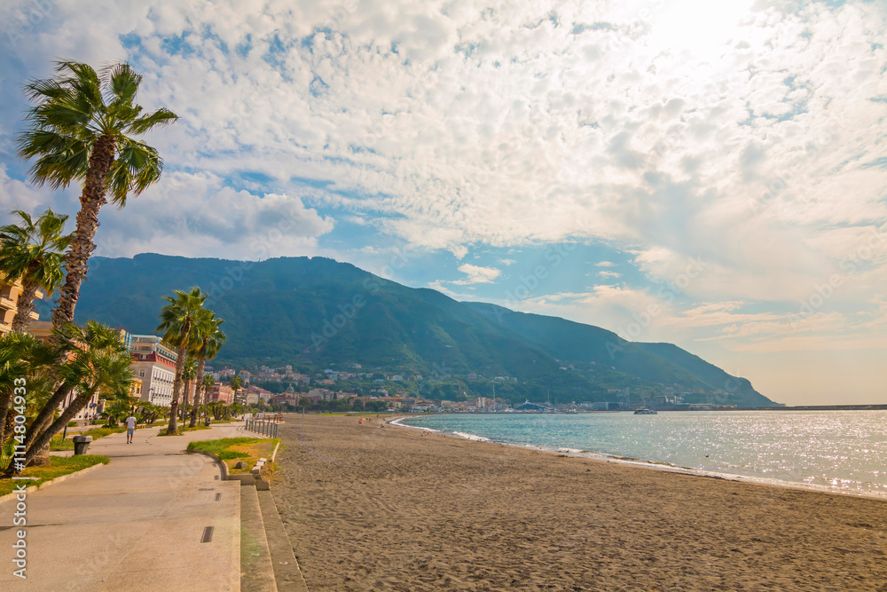 The photo of Naples, a vibrant Italian city, with its historic architecture, bustling streets, and the iconic Mount Vesuvius in the background, set against a blue sky