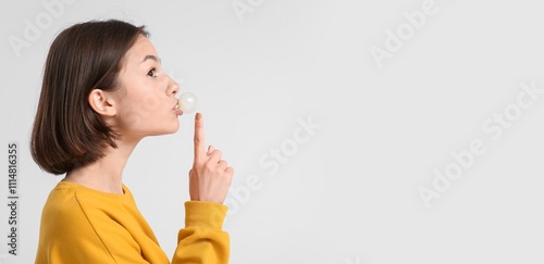 Young woman with chewing gu...